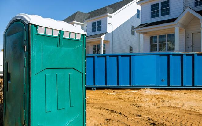 portable toilet and dumpster at a construction site in Alpharetta GA